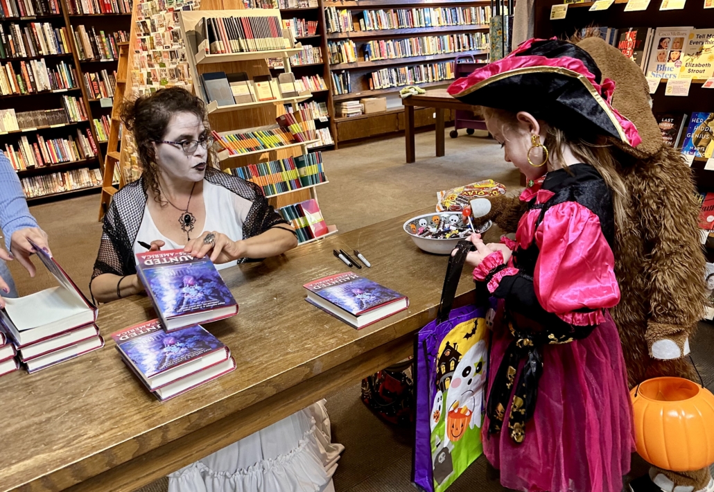 Author Silvia Acevedo in costume greeting costumed kids and signs books after reading her spooky tale from THE HAUNTED STATES OF AMERICA book