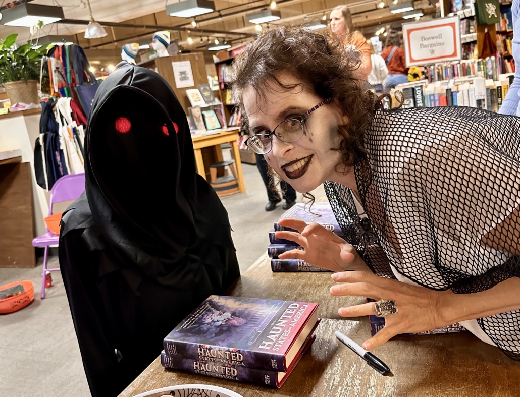 Author Silvia Acevedo in costume greeting costumed kids and signs books after reading her spooky tale from THE HAUNTED STATES OF AMERICA book