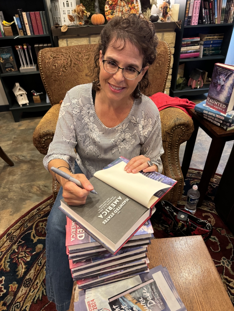 Author Silvia Acevedo signs her book THE HAUNTED STATES OF AMERICA at Daydream Believer Books and Gifts in Lake Mills, Wisconsin